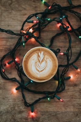 latte art surrounded by Christmas light
