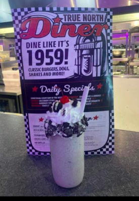 milkshake in front of a diner menu