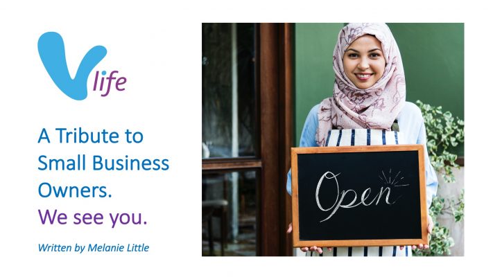 Islamic woman small business owner holding blackboard with smiling.2023-02-01 vLife Blog image Tribute to Small Business Owners